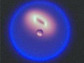 Flame with tear-drop shape on Earth and round shape in microgravity